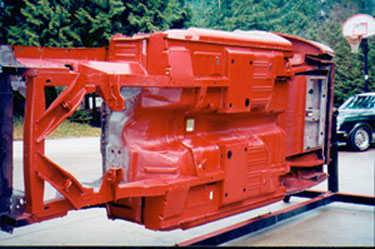 This photo shows a red oxide unibody ready for body color.
